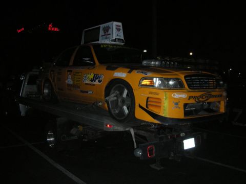 1992 Ford Crown Victoria - Modified yellow taxi with ProCharger supercharger is loaded onto a tow truck at night.