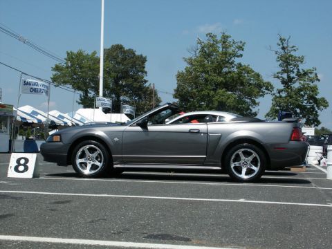 2001 Mercury Grand Marquis - A gray convertible sports car is parked at an outdoor event, viewed from the side.