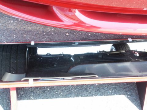 2001 Mercury Grand Marquis - The underside of a red vehicle is visible, revealing mechanical components and a tire.