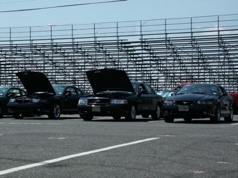 2001 Mercury Grand Marquis - Several cars are parked in a lot with bleachers in the background. The 2001 Mercury Grand Marquis is in the foreground.