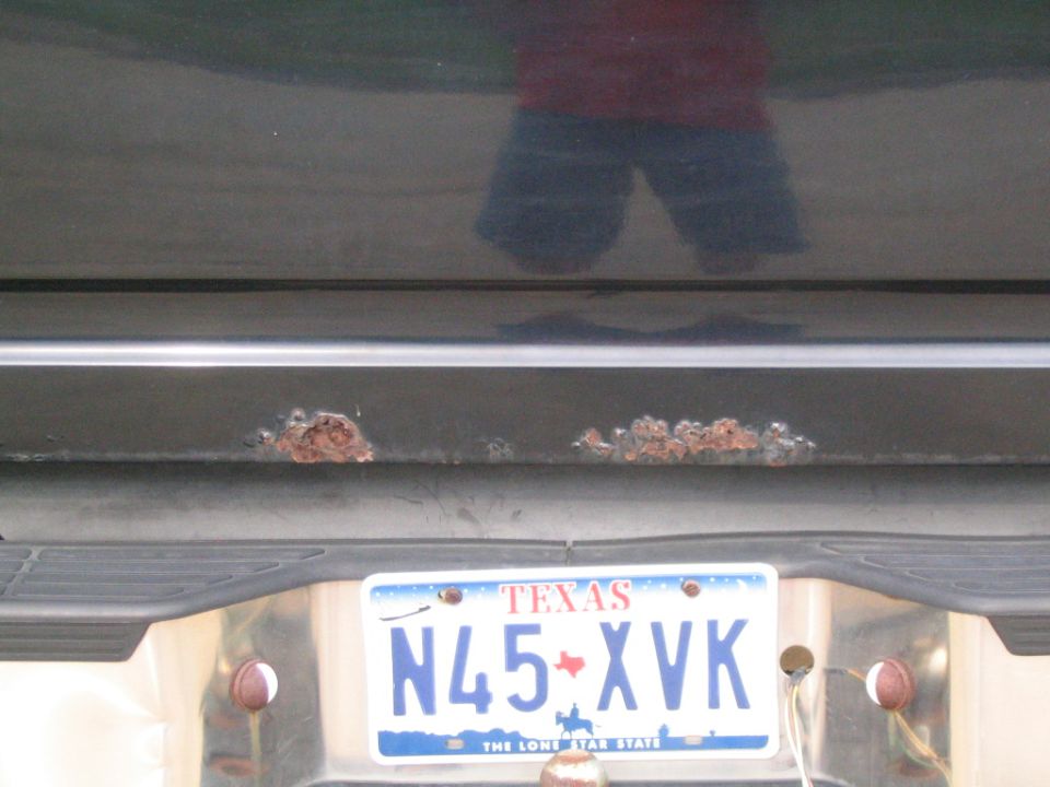 Rear bumper with rust spots and Texas license plate N45-XVK