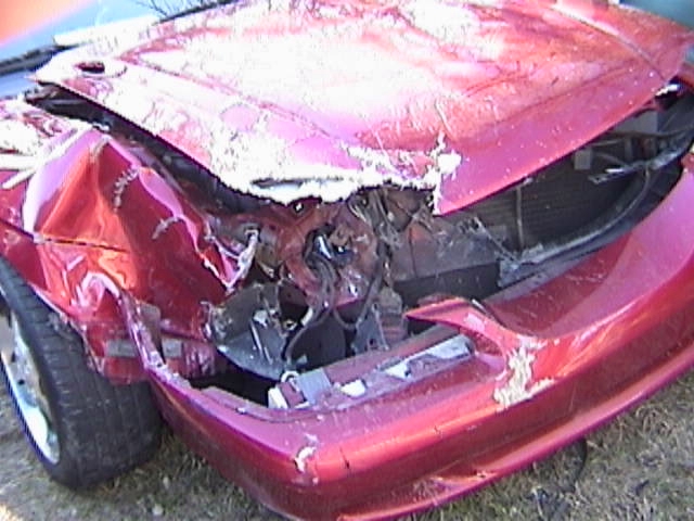 Red car with heavily damaged front end