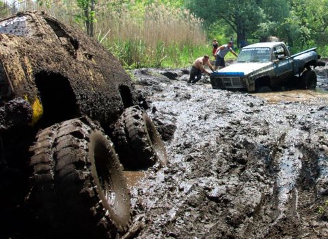 1978 Ford Bronco - Off-road vehicles are stuck in deep mud during an event.