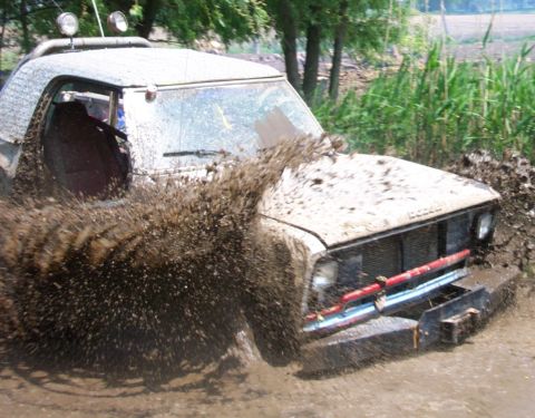 1978 Ford Bronco - This 1978 Ford Bronco navigates a muddy obstacle course, kicking up a large spray of dirt.