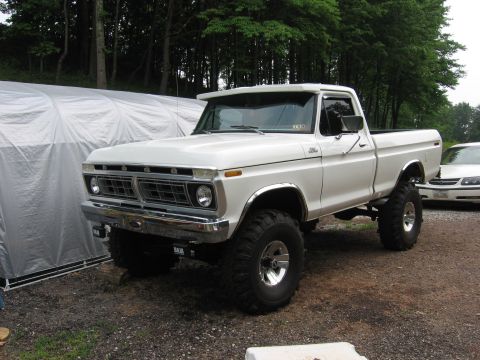 1974 Ford F-100 - This lifted pickup truck features a distinctive grille and chrome trim, suggesting a mid-1970s model year.