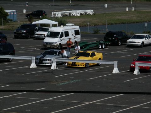 2001 Mercury Grand Marquis - A parking lot scene shows several vehicles including a van and sports cars.