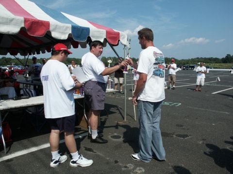 2001 Mercury Grand Marquis - Awards are being handed out under a tent at an outdoor car show event.