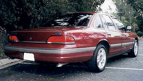 1992 Ford Crown Victoria - Rear view of a 1992 Ford Crown Victoria sedan in dark red.