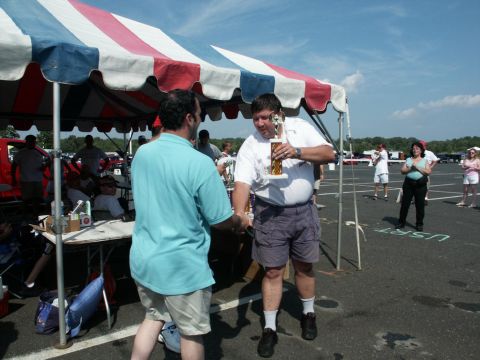 2001 Mercury Grand Marquis - A trophy is awarded at an outdoor event, possibly a car show, with a tent providing shade.