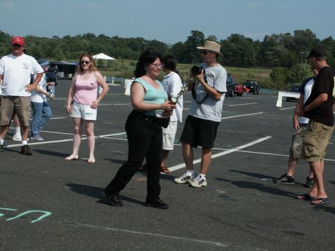 2001 Mercury Grand Marquis - Attendees mingle in a parking lot during a car show event, with several vehicles visible in the background.