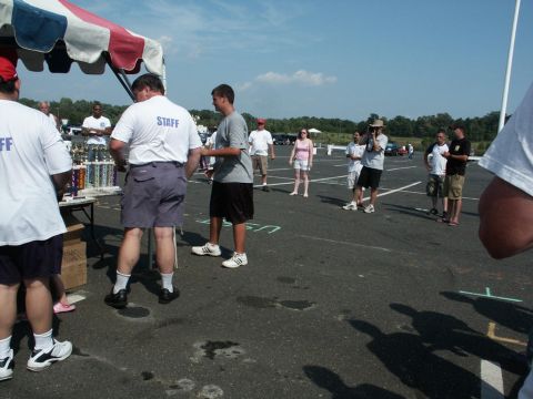 2001 Mercury Grand Marquis - An outdoor event with people milling around a tent and trophies displayed on a table.
