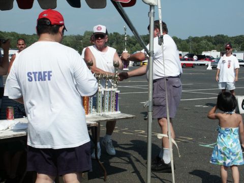 2001 Mercury Grand Marquis - Staff members hand out trophies at the 4th Annual CJMF Car/Truck Show, with several vehicles visible in the background.
