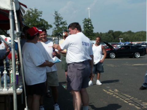 2001 Mercury Grand Marquis - Awards are given out at a car show event, with several vehicles visible in the background.