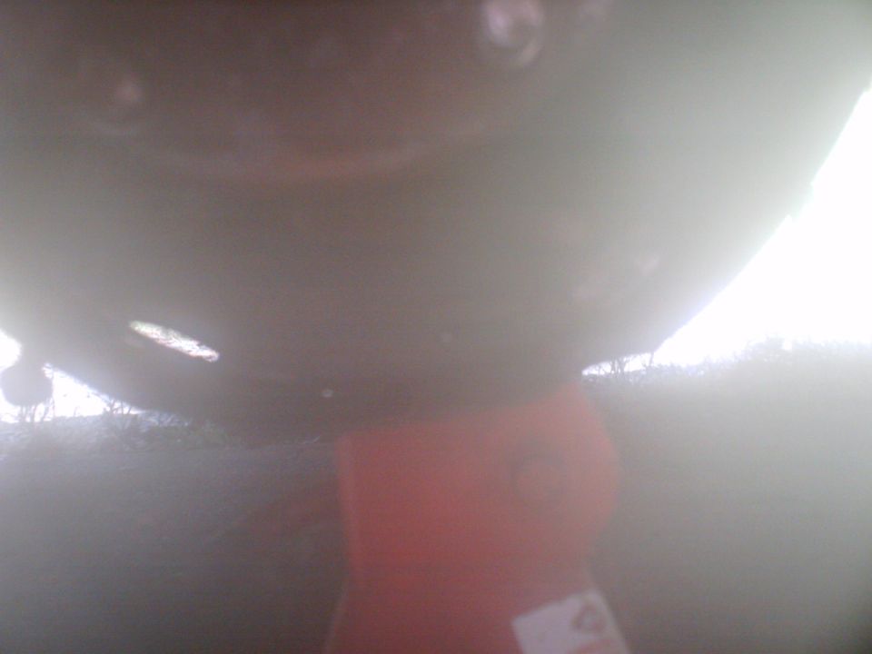 ....the only damage done when the wheel and drum came off at 65mph, thank goodness, I appologize for the low visibility and non-clarity of the pic, its of the backing plate for the drum, flat and ground up from the road....next....