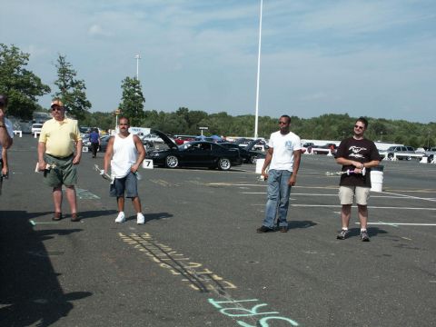 2001 Mercury Grand Marquis - Several people are gathered in a parking lot during a car show, with multiple vehicles visible in the background.