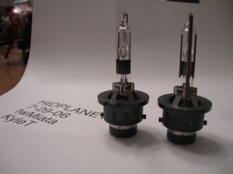 1996 Toyota 4Runner - Two HID bulbs are shown on a white surface with handwritten text and a SuperMotors logo visible.