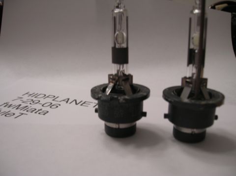 1996 Toyota 4Runner - Two HID bulbs are shown on a piece of paper with handwritten text, including a date and vehicle model.