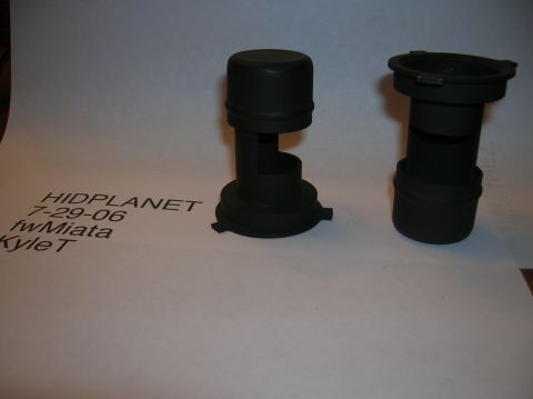 1996 Toyota 4Runner - Two black plastic automotive headlight dust caps are shown against a white background with printed text.
