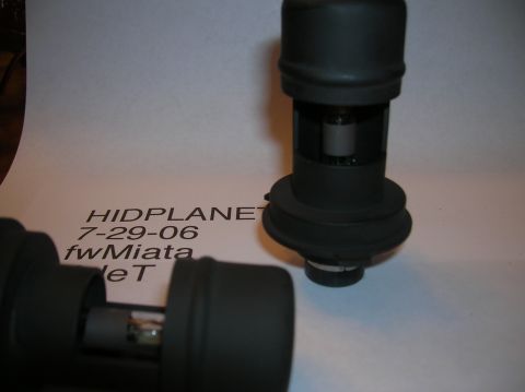 1996 Toyota 4Runner - Two automotive headlight bulbs are shown against a white background with visible text and a SuperMotors watermark.