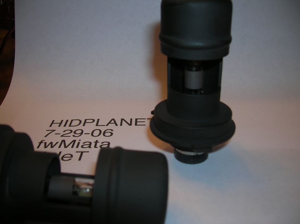 Two black automotive headlight bulbs on a white background with text