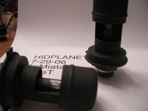 1996 Toyota 4Runner - Two HID headlight bulbs are shown on a paper with text.