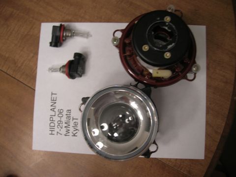 1996 Toyota 4Runner - Disassembled headlight assembly and bulbs laid out on a table with text visible.
