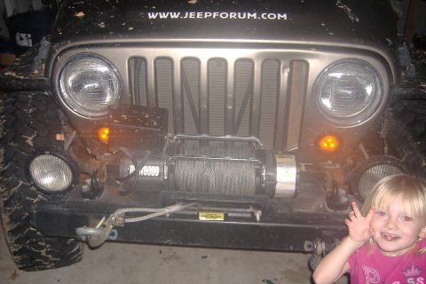 2004 Jeep Wrangler - Front view of a 2004 Jeep Wrangler showing its grille, headlights, and a winch.