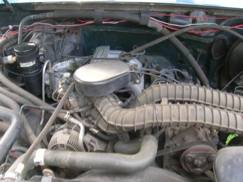 1994 Ford F-150 - Close-up view of a vehicle's engine compartment, showing various mechanical parts and wiring.