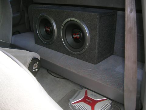 1994 Ford F-150 - Dual subwoofers and amplifier installed in the rear of a vehicle's interior.