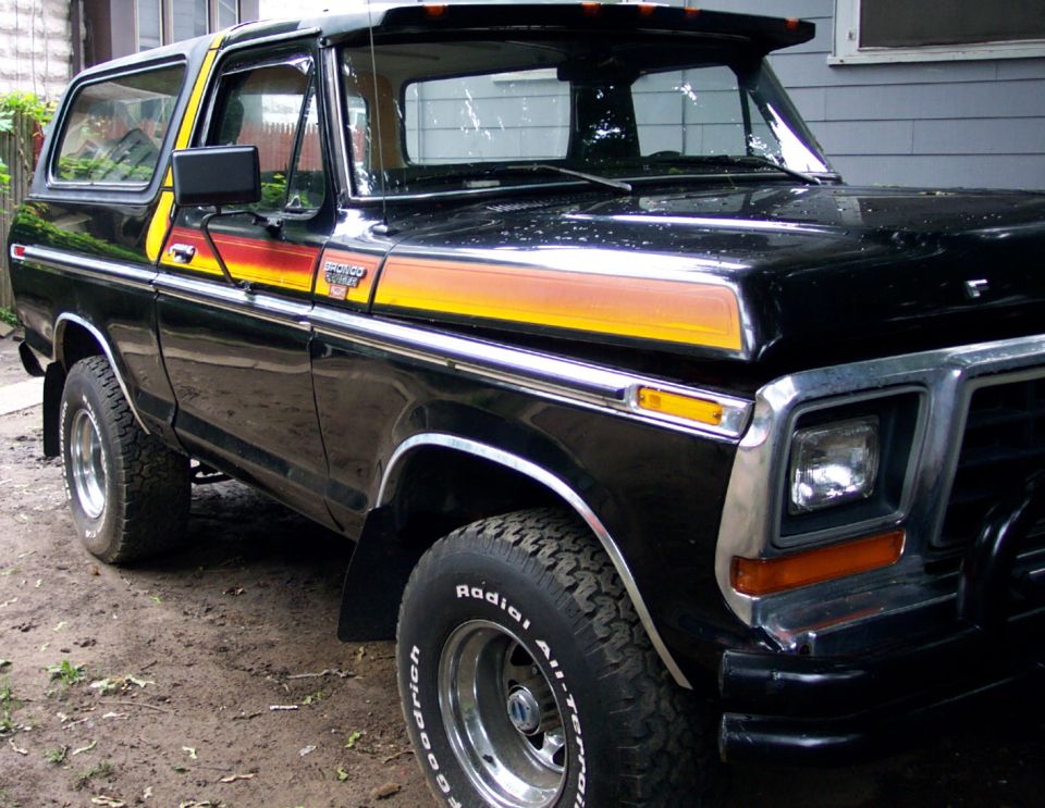 Black Ford Bronco with orange and yellow stripe decals on the side