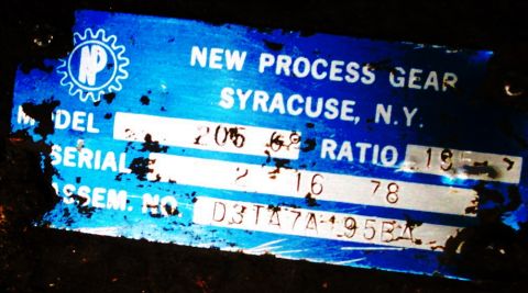 1978 Ford Bronco - A close-up of a blue metal data plate from New Process Gear, Syracuse, N.Y., with visible numbers and text.