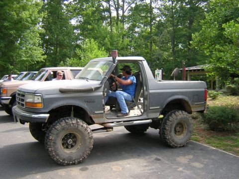 1979 Ford Bronco - A modified gray Ford Bronco with large tires and a snorkel is parked outdoors.