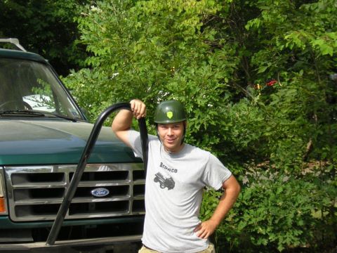 1979 Ford Bronco - A man poses with a green Ford truck, which appears to be from the early to mid-1990s, not a 1979 model.