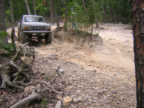 1979 Ford Bronco - This Ford F-Series truck navigates a challenging off-road course in a wooded area.