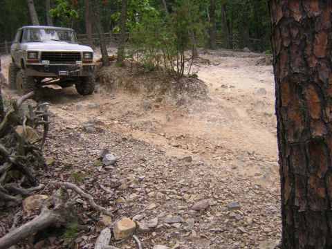 1979 Ford Bronco - Silver 1978 Ford Bronco navigating a challenging off-road course.