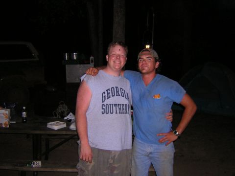 1979 Ford Bronco - Two friends are posing for a photo at a campsite with a tent and picnic table visible in the background.