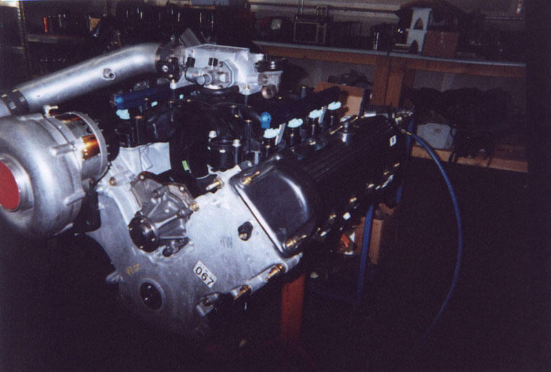 Supercharged V8 engine on a shop stand with blue-topped injectors
