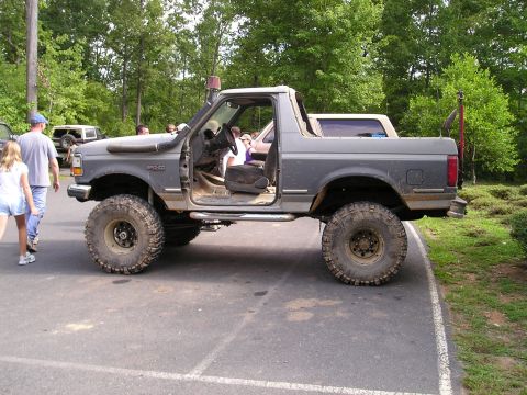 1996 Ford Bronco - Modified 1996 Ford Bronco with snorkel and large off-road tires is shown from the side.