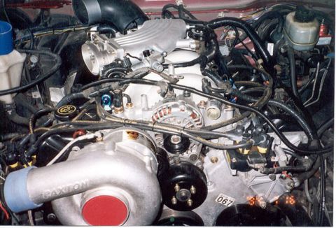 1992 Ford Crown Victoria - Overhead engine bay shot showing a V8 engine with a Paxton centrifugal supercharger mounted low on the driver's side, aluminum intake manif…