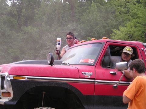 1996 Ford Bronco - A red pickup truck, possibly a 1978 model, is shown with people inside and a Bronco badge on the fender.
