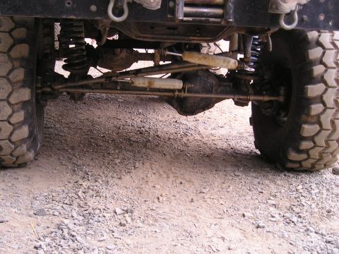 1996 Ford Bronco - Undercarriage view of a 4x4 vehicle's front suspension and drivetrain components.