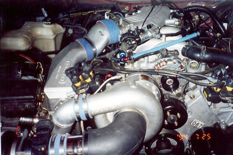 Paxton supercharger and aluminum intake tubing with blue couplers on a fuel-injected V8