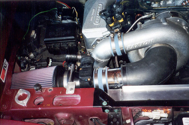 Ford engine bay with polished Paxton supercharger, K&N cone filter and cast tubing