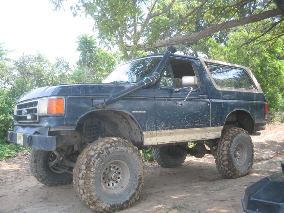 Dark blue 1990 Ford Bronco with snorkel and lifted suspension