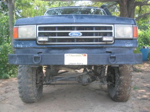 1990 Ford Bronco - Front view of a 1990 Ford Bronco, showing the grille, headlights, and bumper.