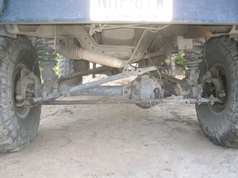 1990 Ford Bronco - The underside of a 4x4 vehicle shows its suspension components and differential.