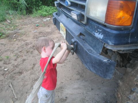 1990 Ford Bronco - Child interacts with tow strap on the front bumper of a 1990 Ford Bronco.