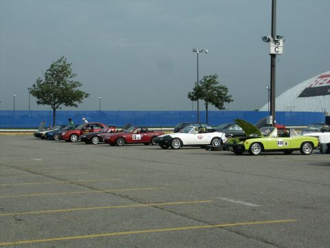 2001 Mercury Grand Marquis - A collection of convertibles are parked in an outdoor lot under a cloudy sky.