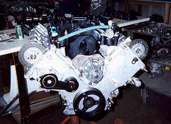 Freshly built Ford DOHC V8 engine on a stand with exposed cam sprockets