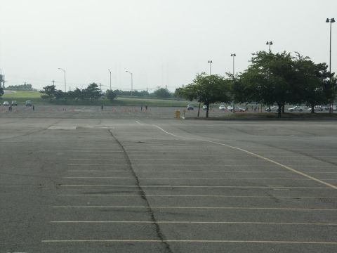 2001 Mercury Grand Marquis - An empty parking lot with cones and distant vehicles suggests an event or training session.
